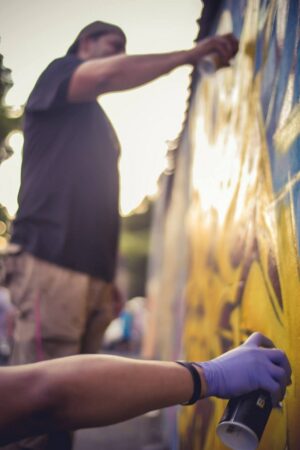 people using spray paint to vandalize Houston custom signs