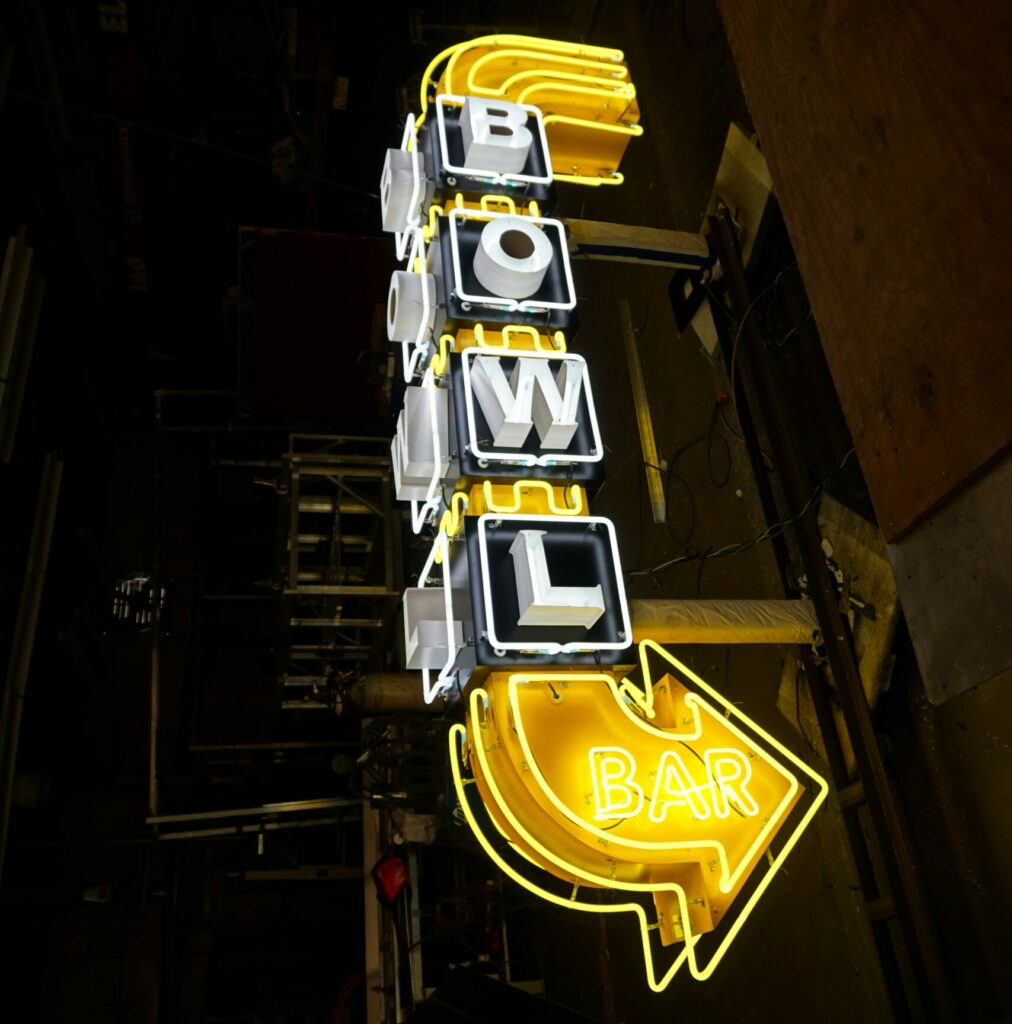 Houston LED sign of yellow arrow for bowling