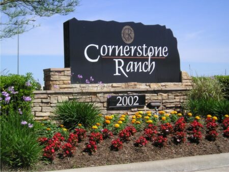 Houston outdoor sign surrounded by shrubs and flowers