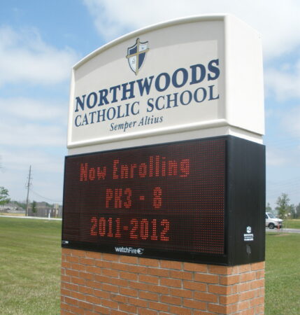 outdoor school sign against cloudy sky created by Houston custom signs 