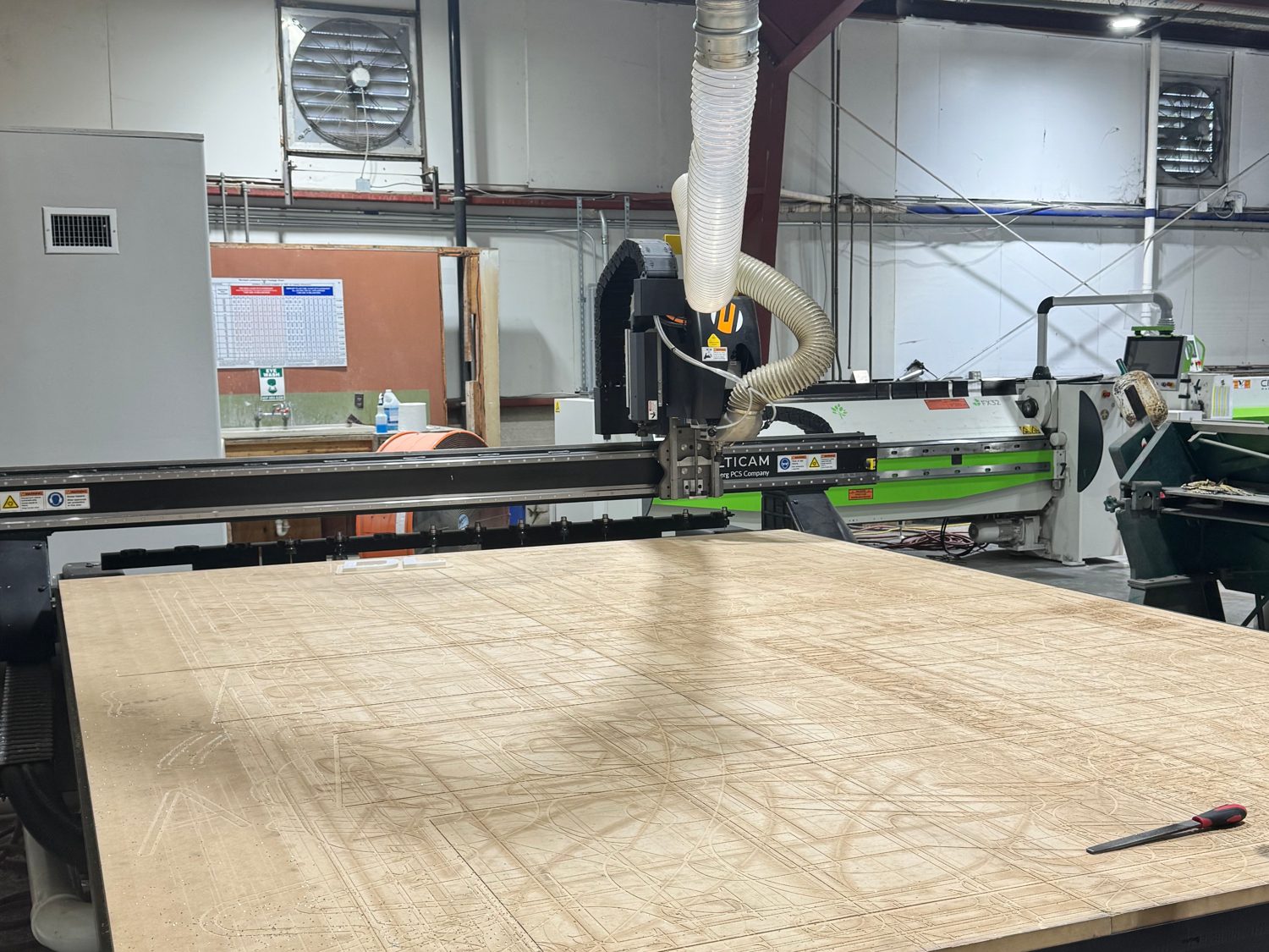 A CNC router cutting sign material on the 4D SignWorx fabrication floor in Houston