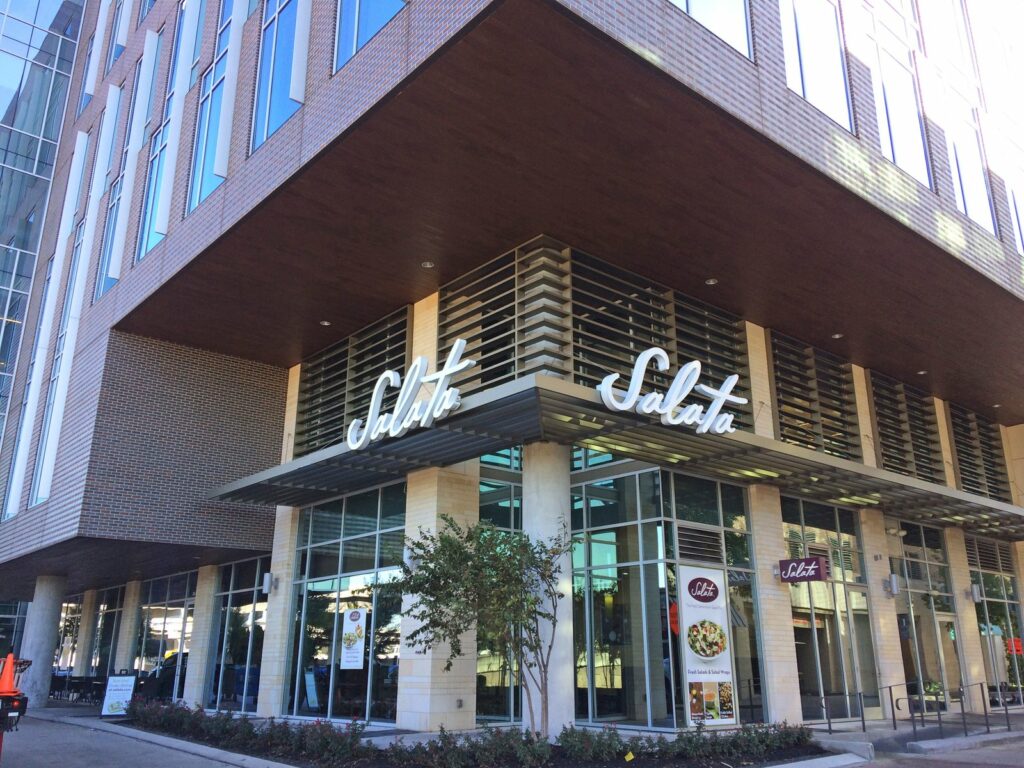 Front-lit channel letter storefront sign at a Houston retail center by 4D SignWorx