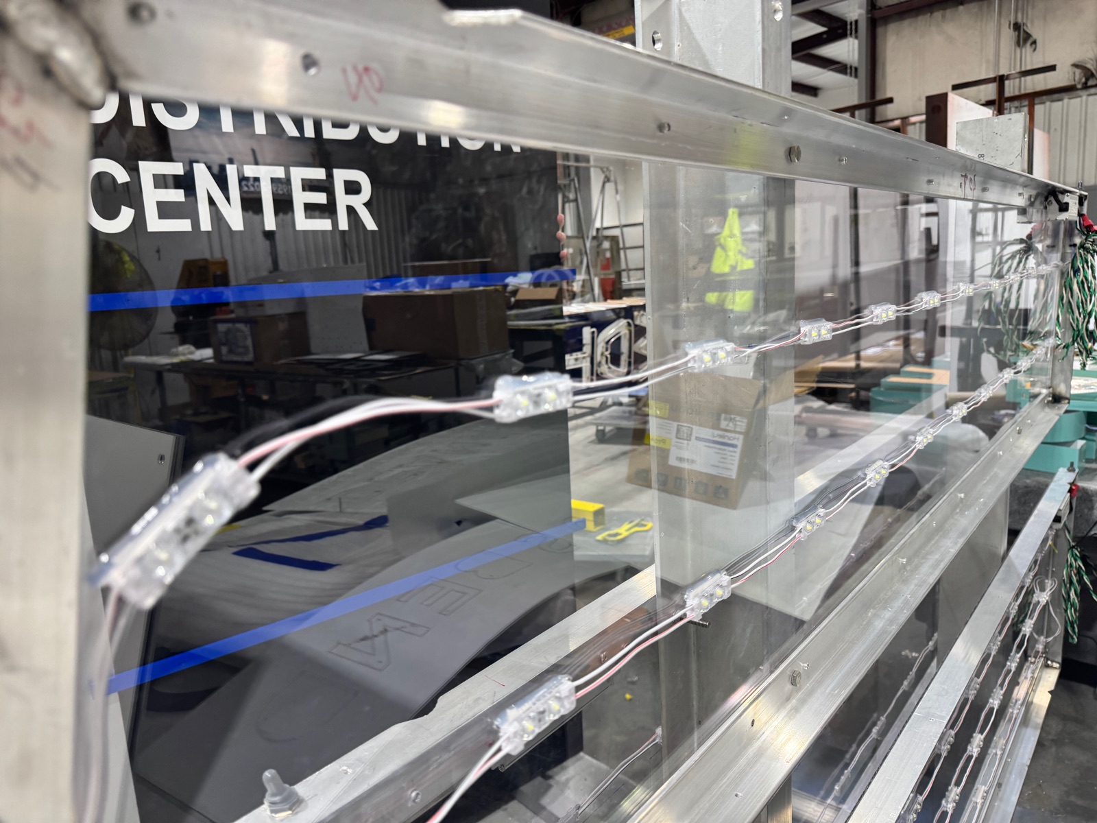 LED modules and acrylic faces wired and laid out for a channel-letter sign on the engineering bench