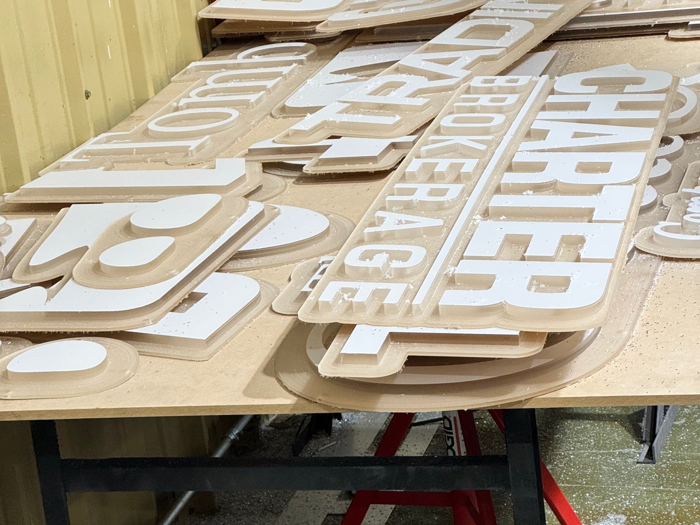 CNC-routed aluminum sign letters laid out in the 4D SignWorx Houston shop