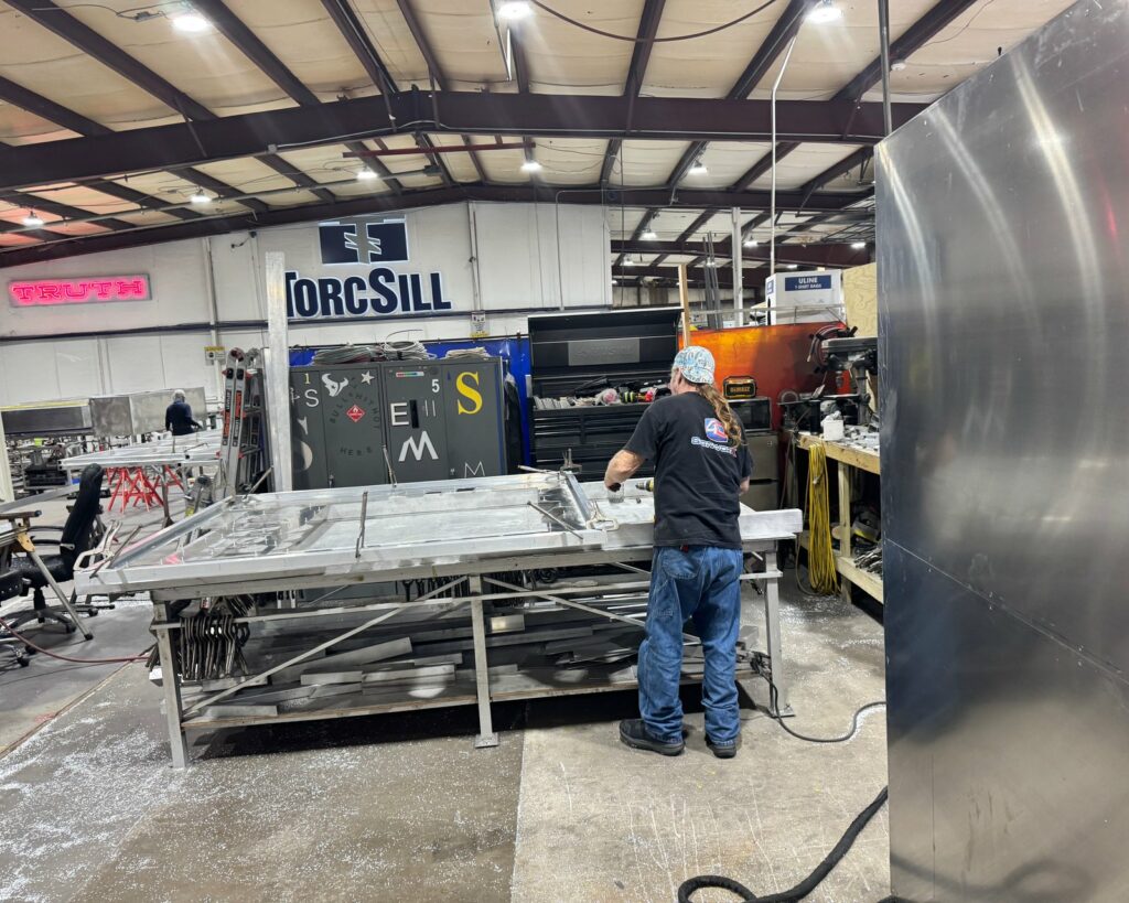 A 4D SignWorx fabricator building a sign on the Houston shop floor