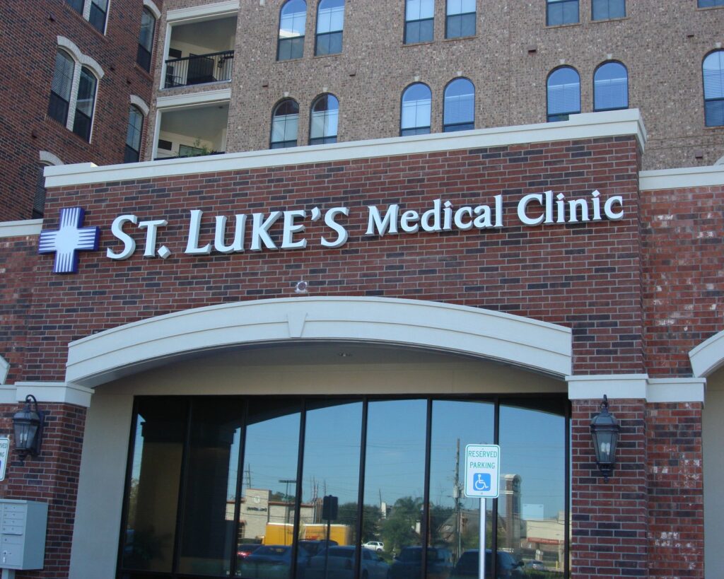 Dimensional letters and cross logo for a St. Luke's Medical Clinic on a brick arcade, built by 4D SignWorx in Houston