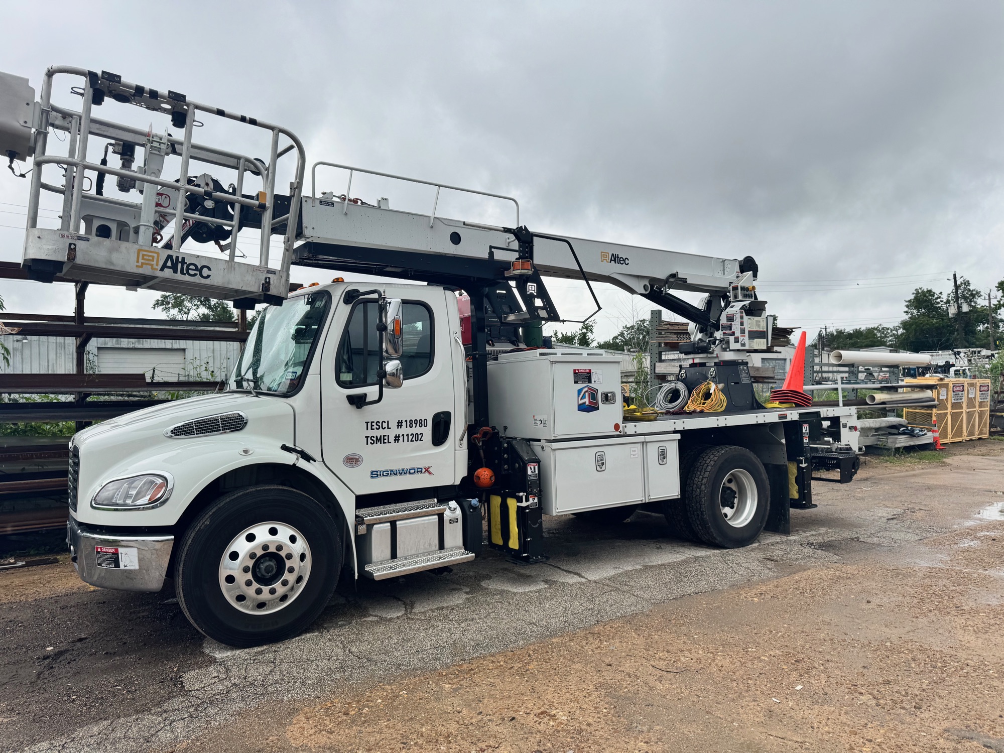 A 4D SignWorx bucket-crane truck staged in the yard for a commercial sign installation