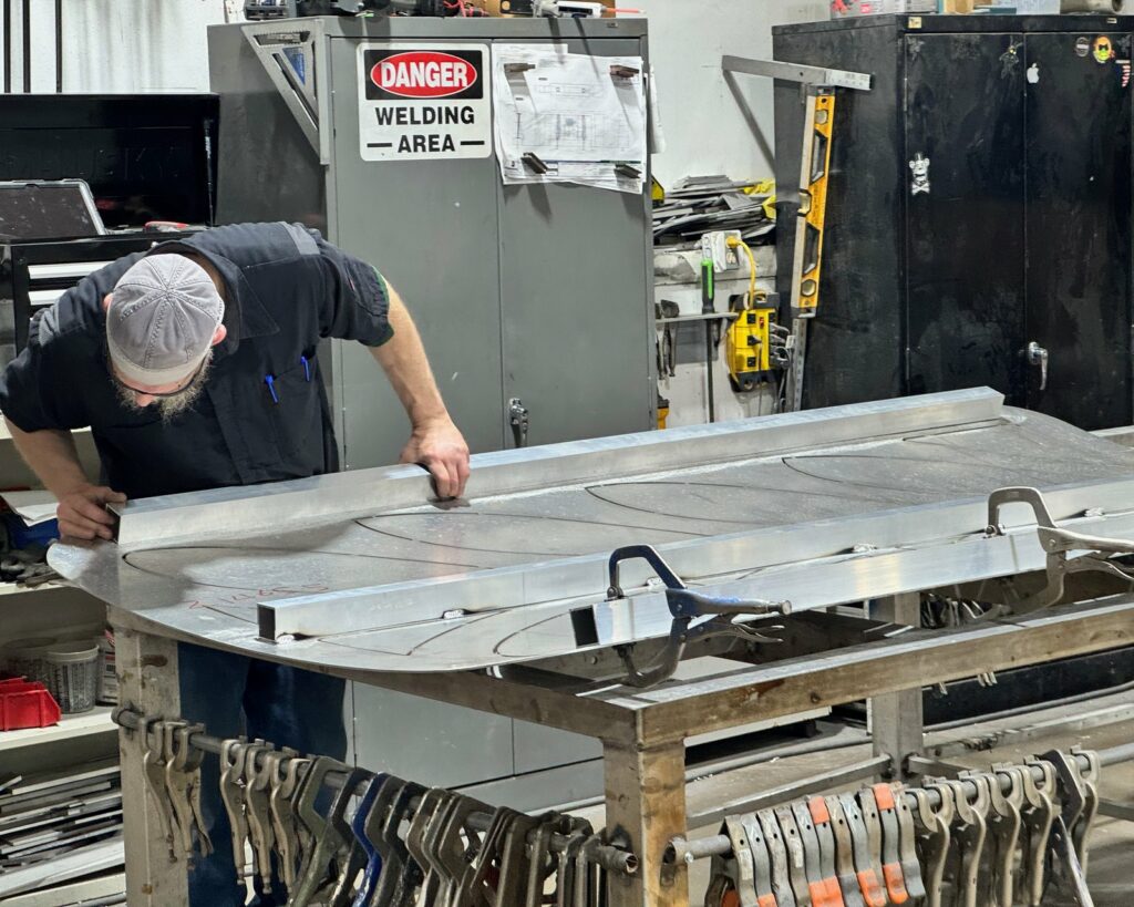 A 4D SignWorx fabricator forming an aluminum sign cabinet in the Houston shop