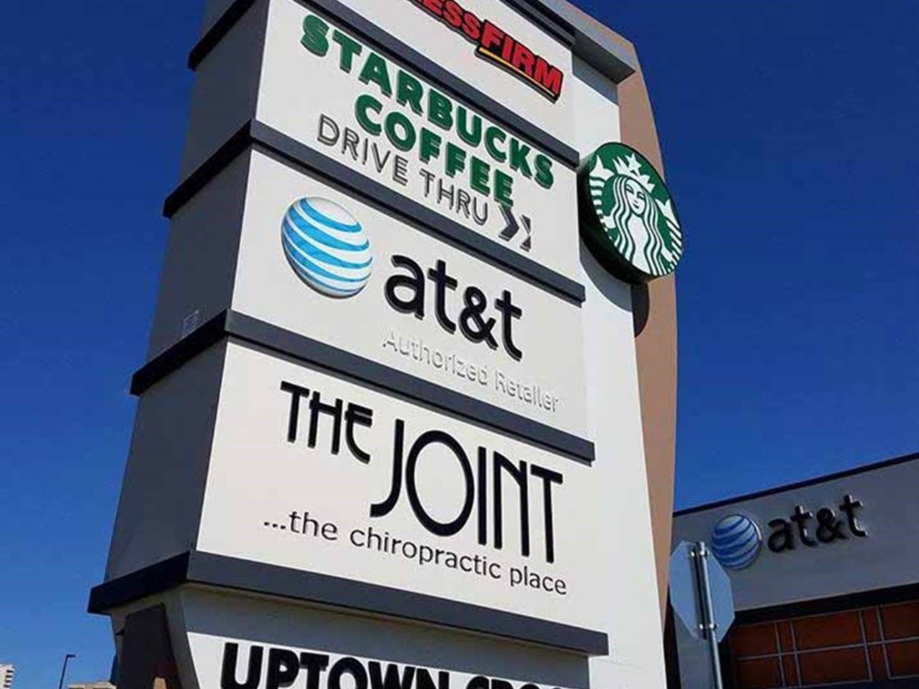 A multi-tenant retail pylon sign with Starbucks and AT&T panels built by 4D SignWorx in Houston