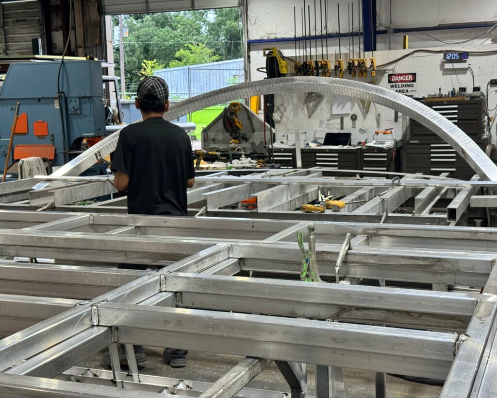 4D SignWorx fabricators building a large aluminum sign structure on the Houston shop floor