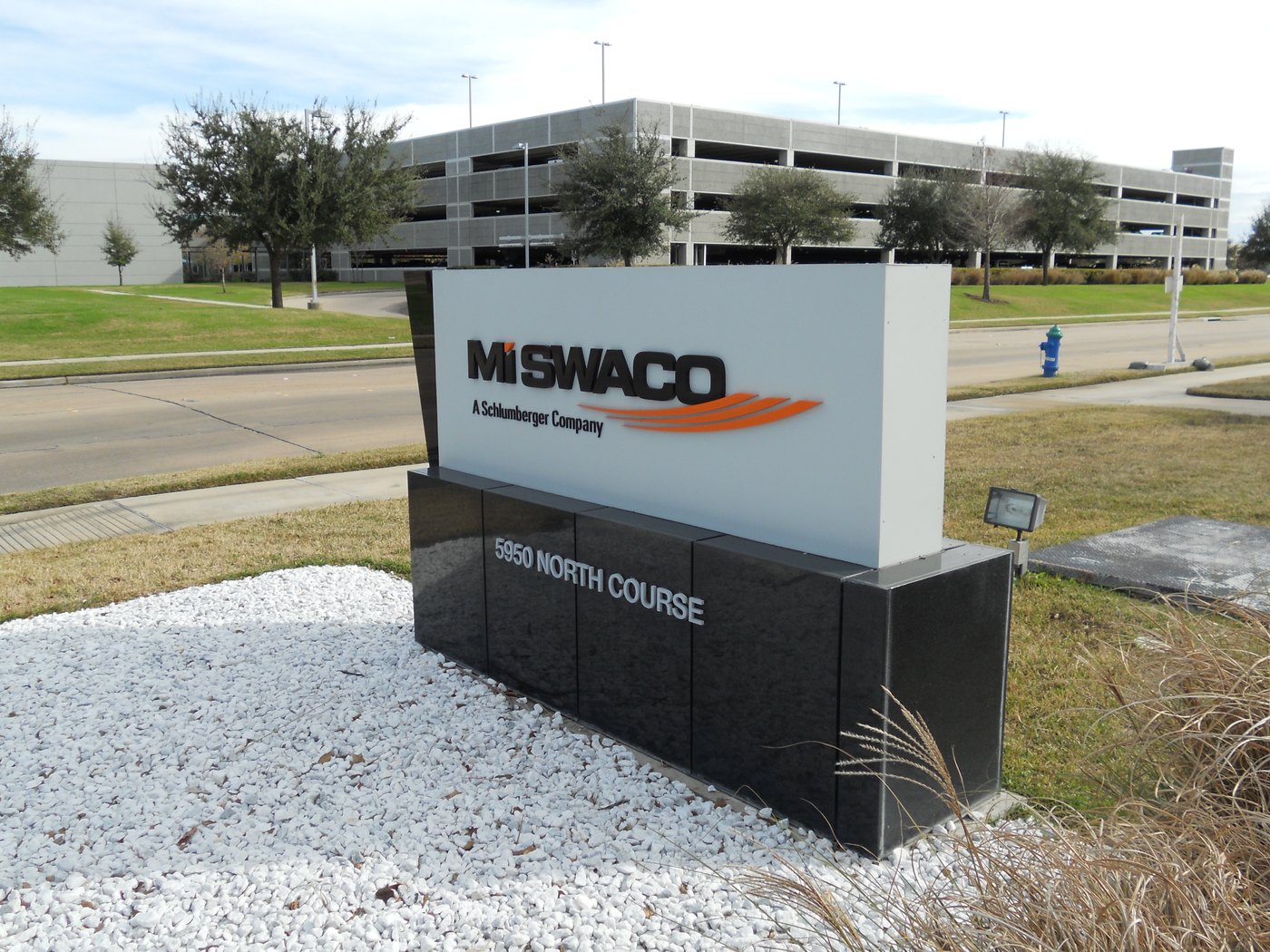 A dark aluminum monument sign for MI SWACO at a Houston industrial campus, built by 4D SignWorx