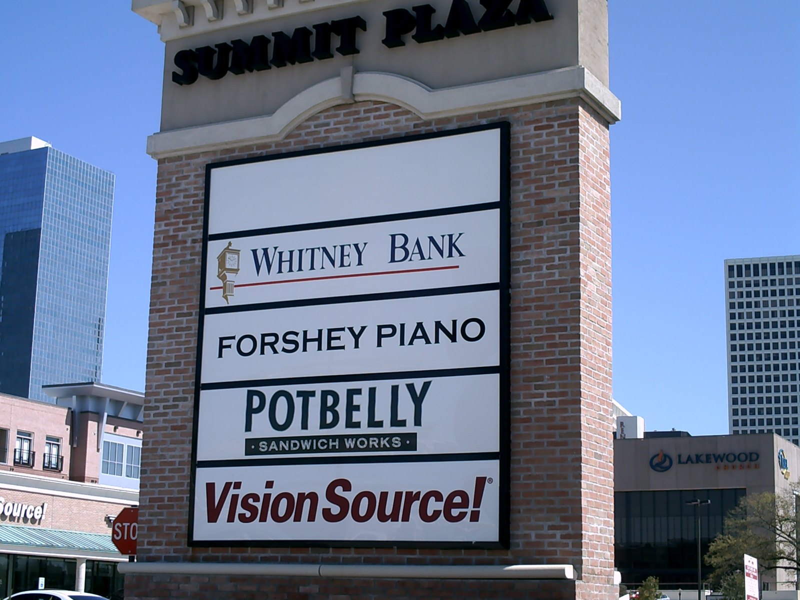 A tall multi-tenant pylon sign with a masonry base and stacked tenant panels for Summit Plaza, engineered and built by 4D SignWorx in Houston