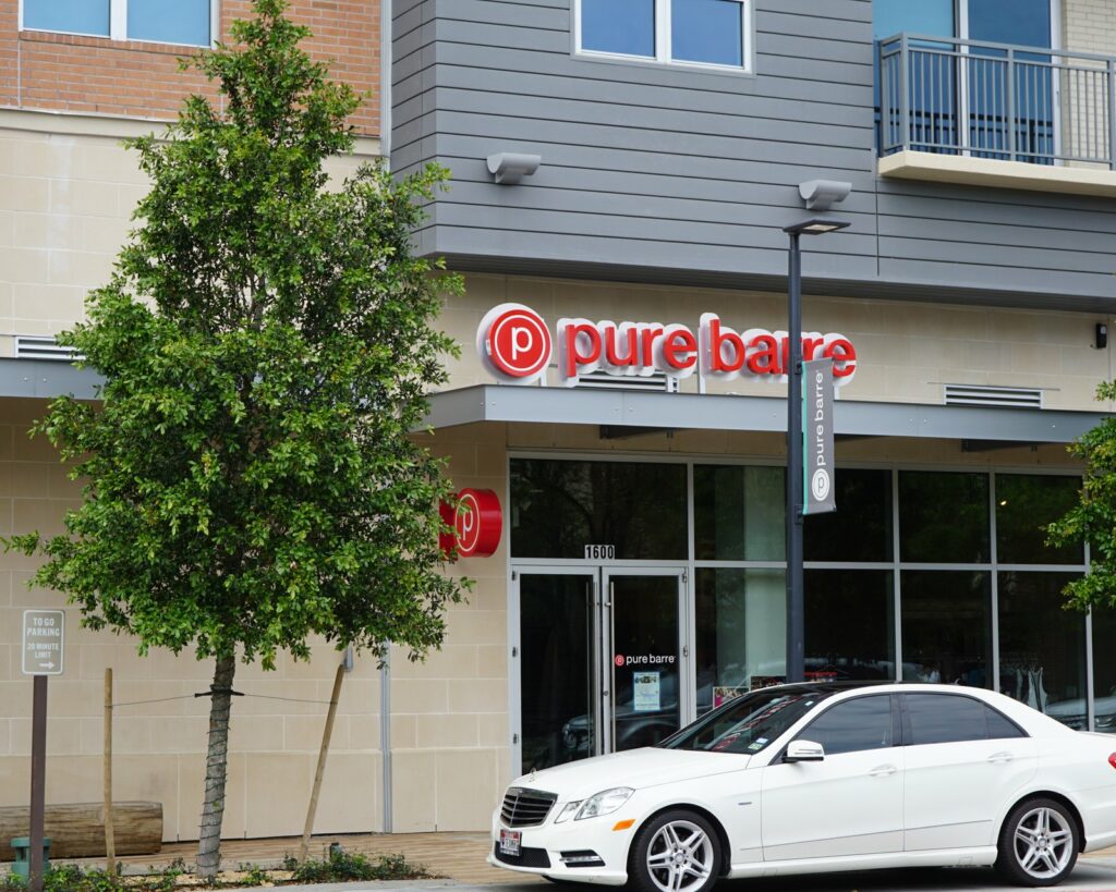 A modern retail center storefront with illuminated tenant signage, built by 4D SignWorx in Houston