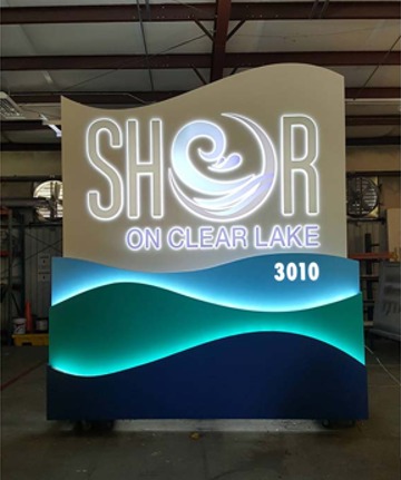 SHOR on Clear Lake illuminated sign lit on the 4D SignWorx shop floor during its 72-hour burn-in test