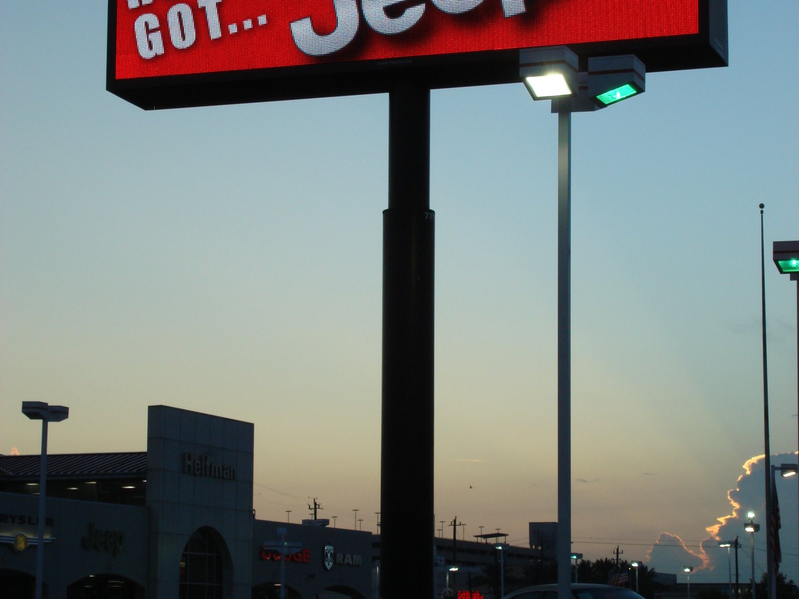 A tall illuminated dealership pole sign at dusk, built by 4D SignWorx
