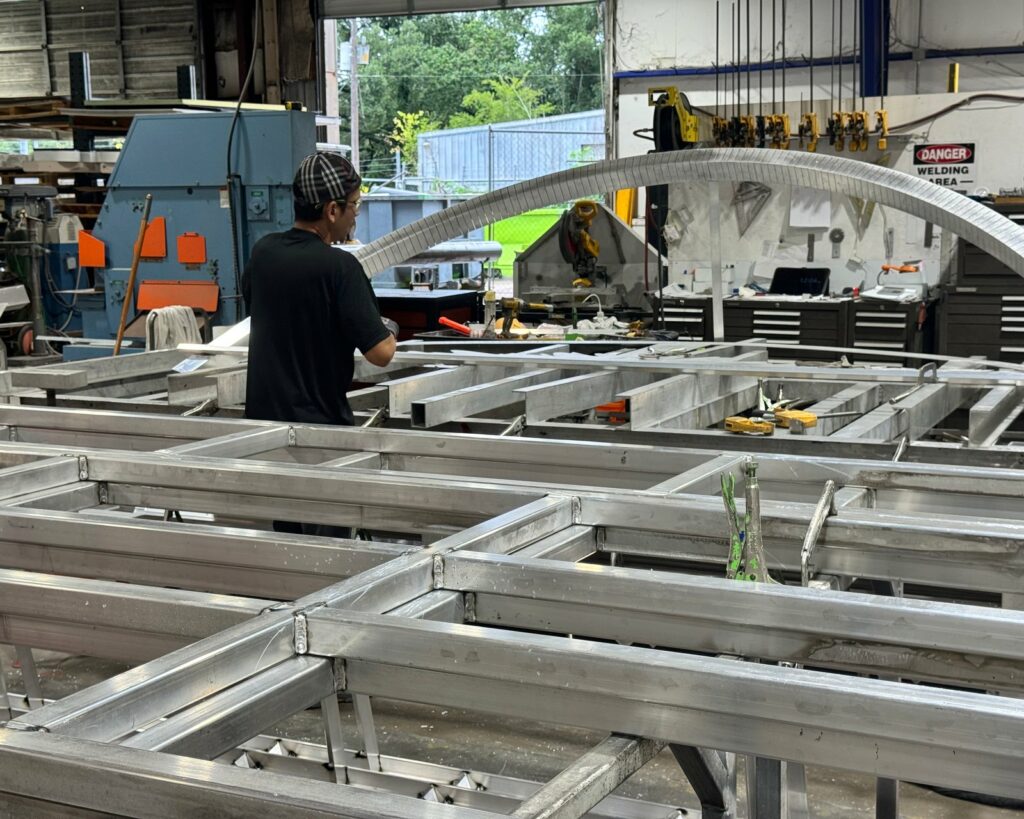 4D SignWorx fabricators assembling a large sign structure in the Houston shop