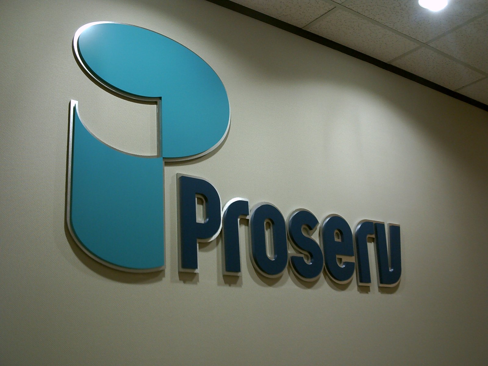 A large teal dimensional logo and lettering wall sign for Proserv, fabricated and installed by 4D SignWorx in Houston